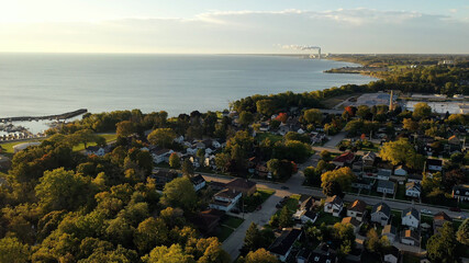 Aerial drone view of suburban neighborhood on the shoreline of Lake Michigan. Establishing shot of...
