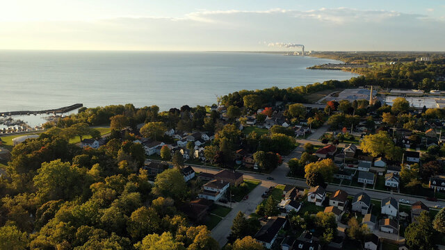 Aerial Drone View Of Suburban Neighborhood On The Shoreline Of Lake Michigan. Establishing Shot Of American Suburb, Street. Residential Houses In Milwaukee, Wisconsin