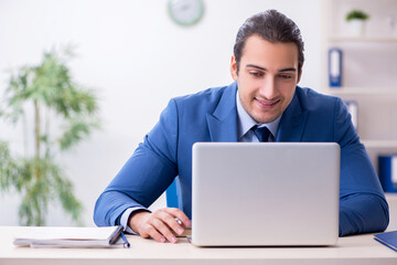 Young male employee in the office