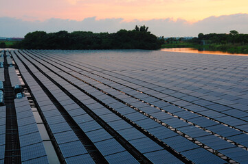 Sunset rays over solar panels on the lake.