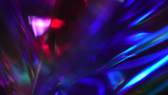Crystal prism refracting light in vivid rainbow colors. Glass dark blue purple metallic holographic background. Beautiful neon modern magic background for Christmas and new year holiday and party