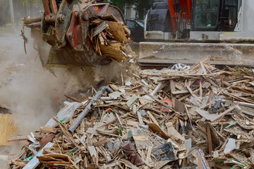 Demolition of wooden house in trash debris outside of neighborhoods devastated by hurricane