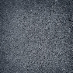 Dark gray surface of rubber pellets in treadmill athletics field texture abstract background