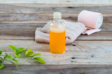 first aid with herbal oil medication liniment and bandage health care pains and aches for athlete decoration on background wooden