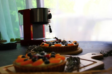 home made mix fruits pie on wood plate orange,blueberry,raspberry,strawberry and low light on window , low light key