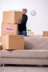 Old male professional mover doing home relocation