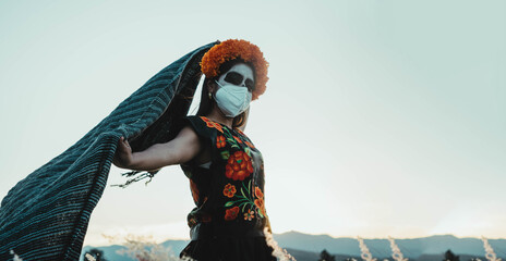 mexican woman on day of the dead with mask