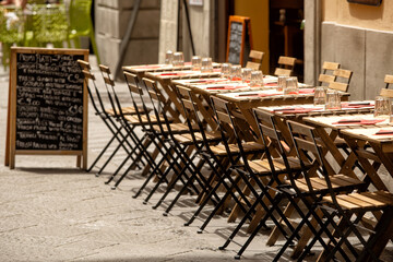 Tables and chairs set up outside a restaurant