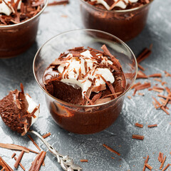 Homemade dark chocolate mousse with whipped cream and crushed chocolate.