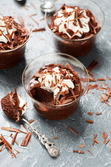 Homemade dark chocolate mousse with whipped cream and crushed chocolate.