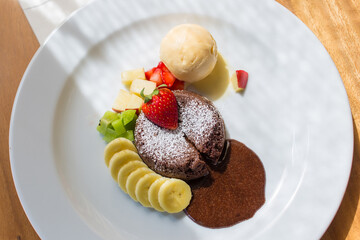 A dessert dish call chocolate lava, include vanilla ice cream, banana, kiwi and apple. This sweet is made from cocoa seed. Good combination between chocolate cake, cold ice cream and fruits.