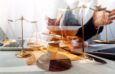 Justice and law concept.Male judge in a courtroom with the gavel, working with, computer and...