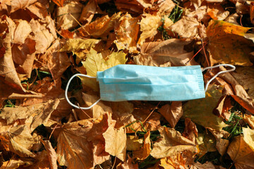 medical face mask on colorful yellow autumn maple leafs coronavirus covid-19 epidemic continues wallpaper
