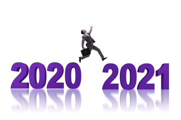 Businessman jumping from the year 2020 to 2021