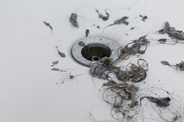 cleaning dirt and hair near drain hole