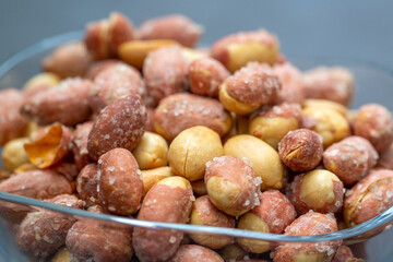 Salted peanuts in a glass bowl