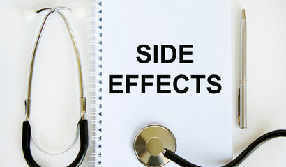 In the notebook, the text is SIDE EFFECTS, a stethoscope and a pen nearby.