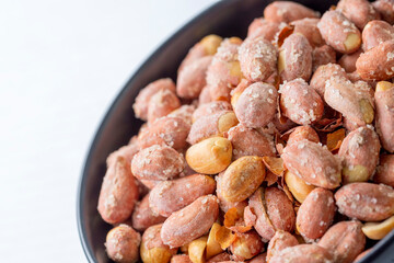 Salted peanuts in a glass bowl