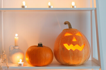 halloween pumpkins with candles on wooden table