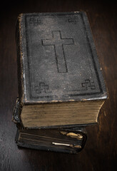 Old Bible on wooden table.