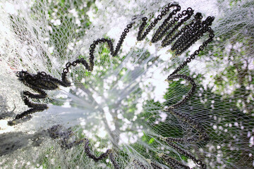 Low angle shot of a fish net weighted by iron chains dry