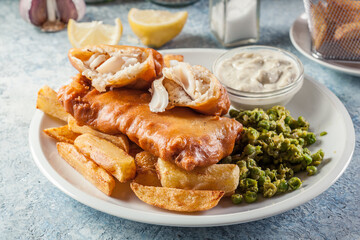 Fish in beer batter and chips with green pea and tartar sauce