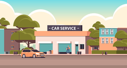 car repair service concept mechanic in uniform repairing tire man working and fixing wheel maintenance station building horizontal vector illustration