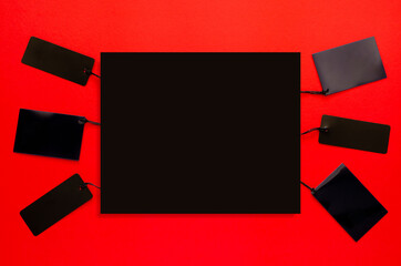 Black price tags with black space for text on red background. Black friday concept.