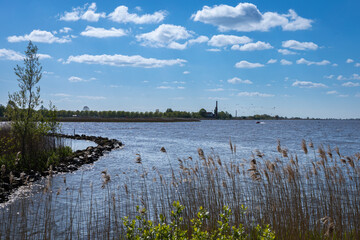Dutch landscape with water and clouds in summer
