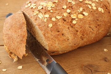 two fresh farmer's breads with a knife