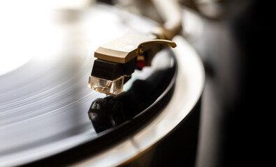Phono or capsule head of reading LP turntable spinning. Close up of turntable vinyl stylus. Playing...
