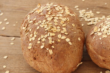 two fresh farmer's breads with a knife
