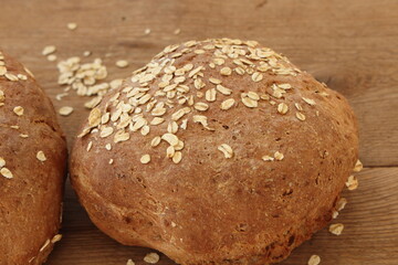 two fresh farmer's breads with a knife