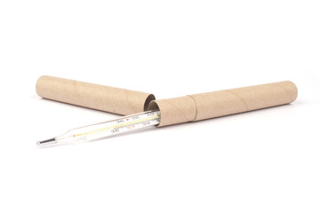 Mockup image of glass mercury thermometer packed in paper tube isolated on white. Medicine and healthcare concept. Catalog photo