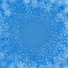 Christmas background of snowflakes of different shape, blur and transparency, arranged in a circle, on light blue background