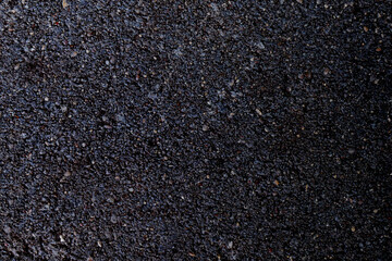 Black background with gradient. Concrete wall with colored small stone splashes. Abstract texture surface. Multicolor spots, copy space, dark moody