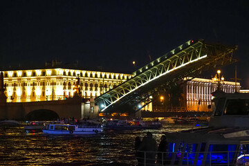 Fototapeta na wymiar Open bridge in Saint Petersburg, Russia. Troitsky bridge at night. Divorced Troitsky Bridge, river ship on Neva river