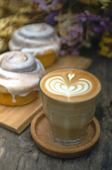 Coffee milk  latte and cinnamon rolls on a wooden table