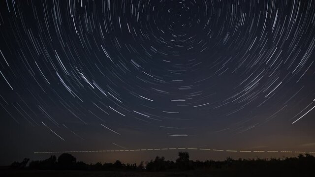 Stars move around a polar star. Time lapse of Star trails in the night sky. 4K
