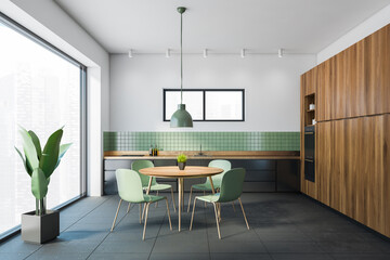 White and green dining room interior with bookcase