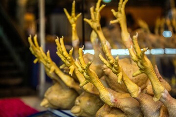 Closeup of fresh chicken claws on the counter in the market.