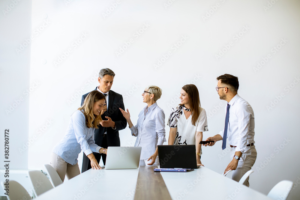 Wall mural Senior businesswoman working together with young business people in office