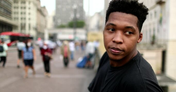 Young black African man in downtown observing city in contemplation