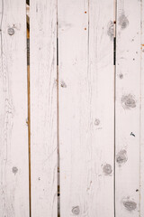 The texture of the white painted wooden fence boards close-up.