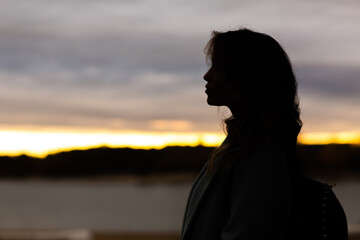 Portrait profile of attractive young woman outside
