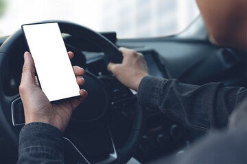Mockup image of man using blank screen mobile phone inside a car