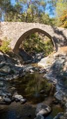 Fototapeta na wymiar Medieval Stone Bridge with river flowing underneath it