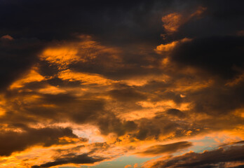 Naklejka na ściany i meble Beautiful sunset. Yellow clouds in the sky (background)