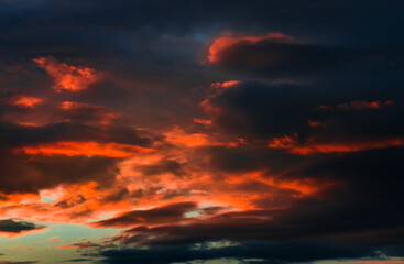 Naklejka na ściany i meble Beautiful sunset. Red and black clouds in the sky