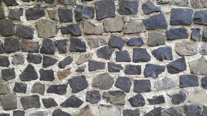 Wall of granite stones. Masonry. Vintage granite background
